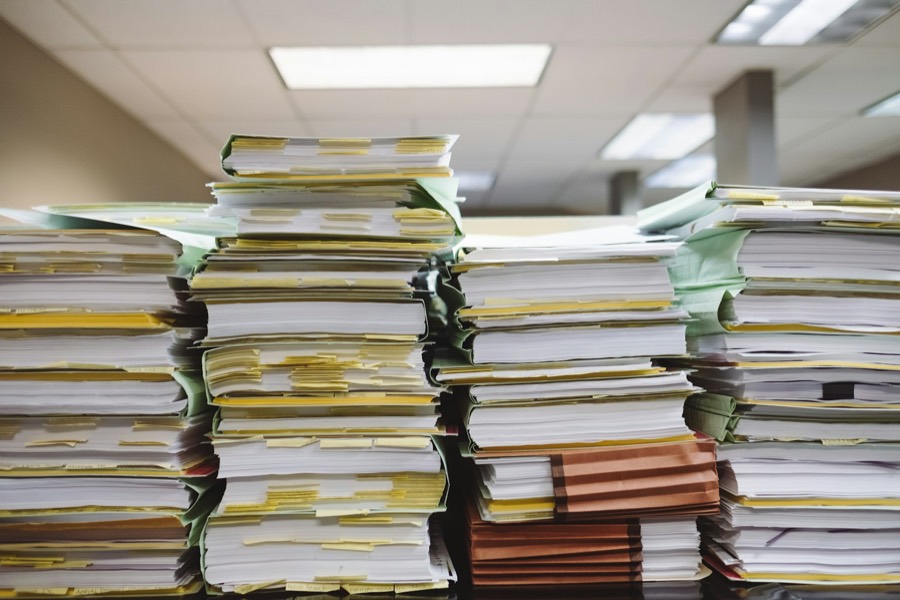 Stacked files and paper records in an office.